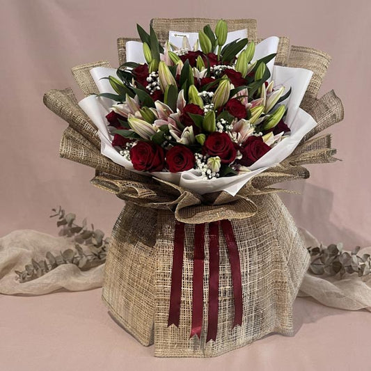 Luxury bouquet with red Ecuadorian roses, stargazer lilies, and baby’s breath fillers