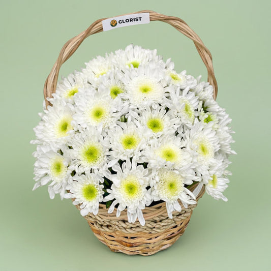 Malaysian mums arranged with fresh greenery in a rustic woven basket, a sympathy and condolence flower gift with same-day Metro Manila delivery