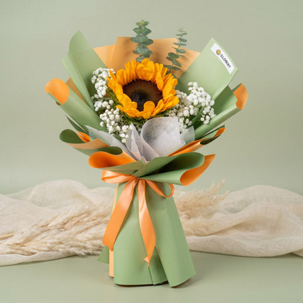 Minimalist sunflower bouquet with eucalyptus and baby’s breath in Korean-style wrapping