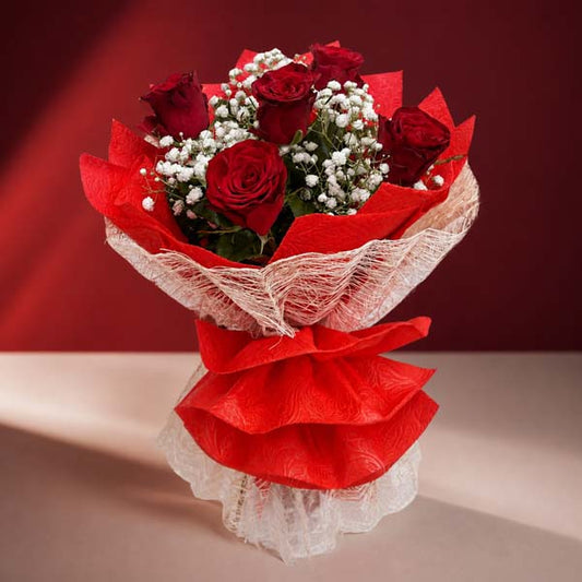 Passion Flora flower bouquet with red China roses, baby’s breath, wrapped in red tissue and burlap