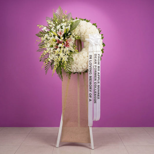 Orchid and white stargazer funeral flower stand arrangement