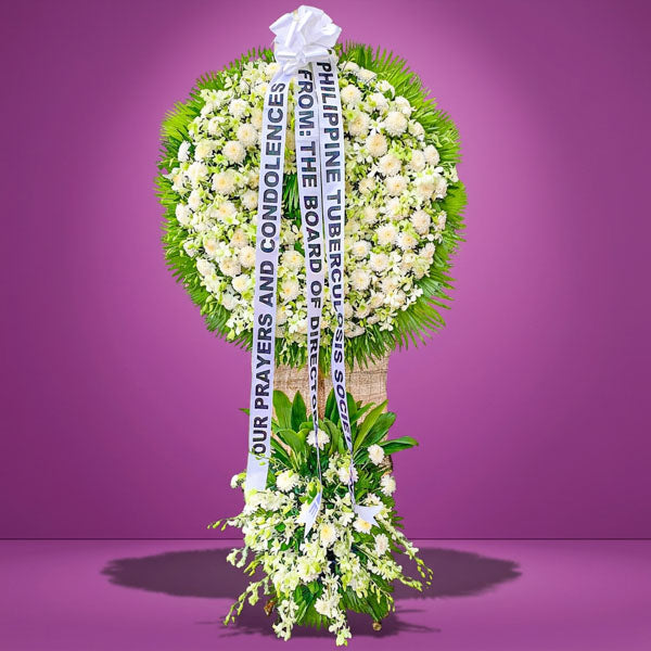 Peaceful Memory Wreath Stand with white chrysanthemums, white orchids, and anahaw leaves