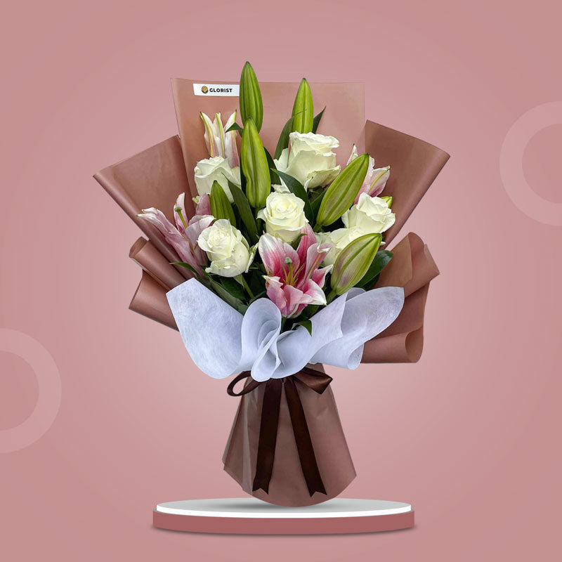 Pearl Love bouquet with stargazer lilies and white roses in brown and white wrap with brown ribbon