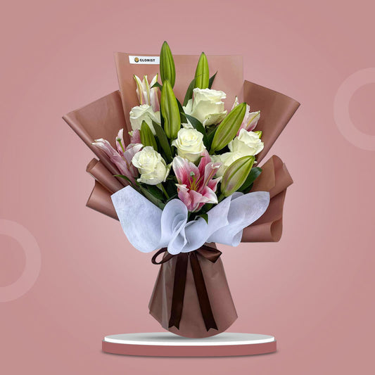 Pearl Love bouquet with stargazer lilies and white roses in brown and white wrap with brown ribbon