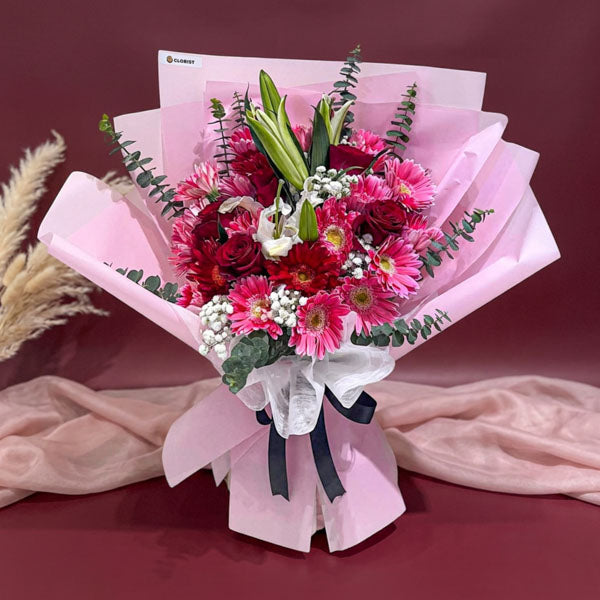 Pink carnation and red rose bouquet with stargazer lily and eucalyptus fillers