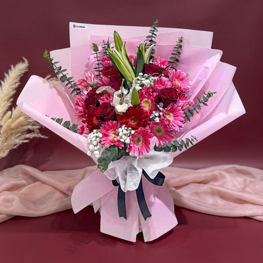 Pink carnation and red rose bouquet with stargazer lily and eucalyptus fillers