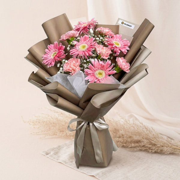 Light pink gerbera and carnation bouquet with baby’s breath in Korean-style wrapping