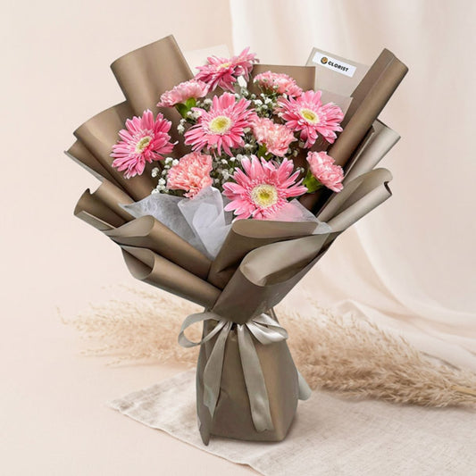 Light pink gerbera and carnation bouquet with baby’s breath in Korean-style wrapping