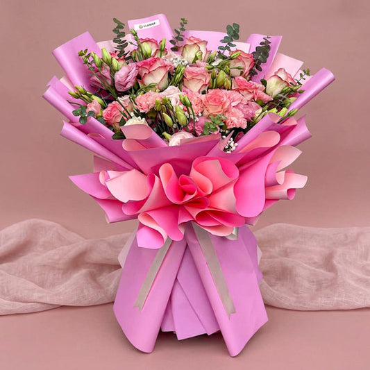 Pink rose and carnation bouquet with lisianthus, baby’s breath, and eucalyptus fillers