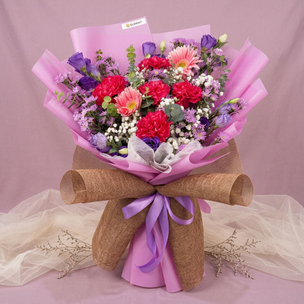 Pink carnation and violet lisianthus bouquet with purple Korean wrapping