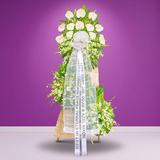 Pure Memory Funeral Stand with anthuriums, orchids, yellow corn leaves, green line, and anahaw — sympathy tribute for Metro Manila