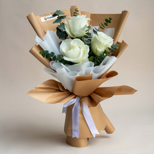 Purity Flora bouquet with 3 white China roses and eucalyptus baby blue in kraft Korean wrap and white non‑woven wrap with white ribbon