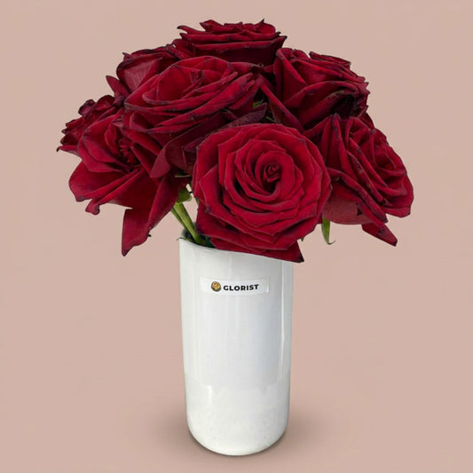 Twelve red Ecuadorian roses arranged in a white glass vase, a luxury anniversary and Valentine's Day flower gift with same-day Metro Manila delivery