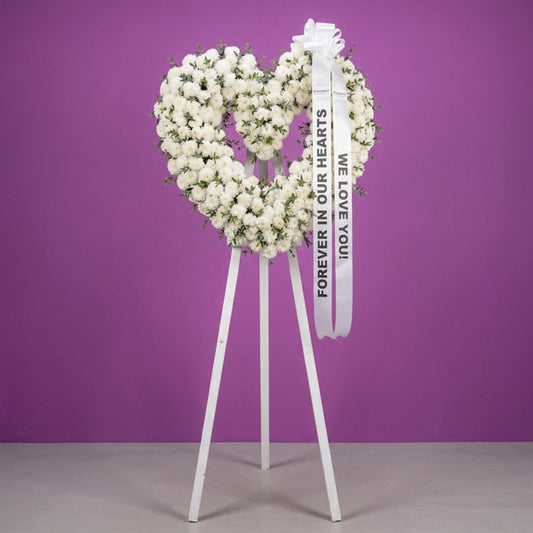 Chrysanthemum funeral flower stand with lush parvi foliage