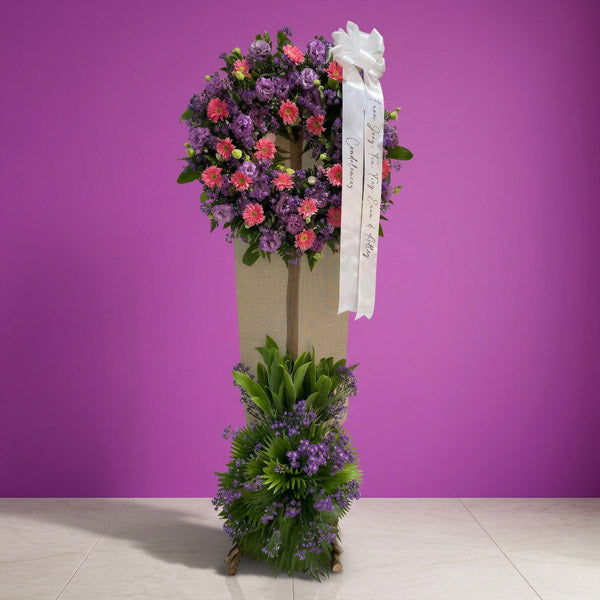 Gerbera and violet aster funeral flower stand arrangement
