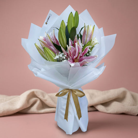 Romantic Breeze bouquet with 3 Stargazer lilies and gypsophila wrapped in white Korean paper with light gold ribbon