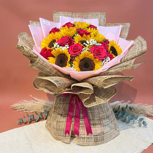 Sunflower and pink Ecuadorian rose bouquet with baby’s breath and burlap wrapping
