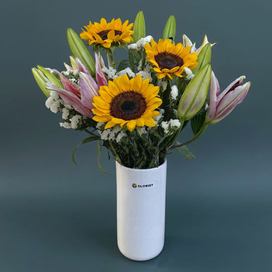 Sunflowers and stargazer lilies with white statice in a modern glass vase, a cheerful birthday and office gift with same-day Metro Manila delivery