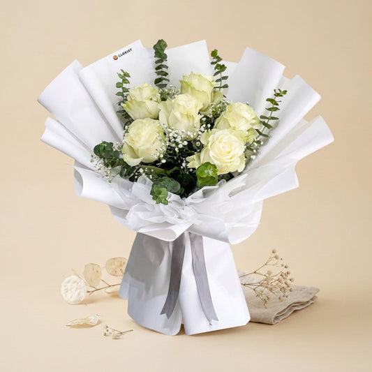 Truthful Dreamland bouquet with white Ecuadorian roses, baby’s breath, and eucalyptus in white Korean wrap and non-woven wrap tied with gray ribbon