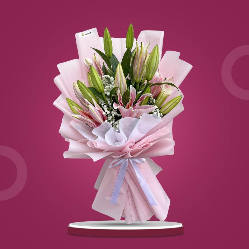 Unfazed Breeze bouquet with 5 stem Stargazer lilies and gypsophila in light pink and white wrap with white ribbon