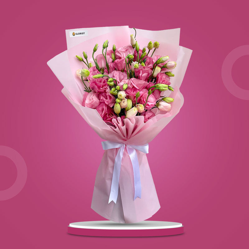 Velvet Fields bouquet with light pink lisianthus paper roses wrapped in pink Korean paper and tied with a white ribbon