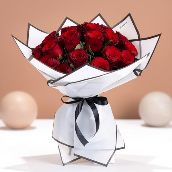 Imported red rose bouquet with white wrapping and black ribbon