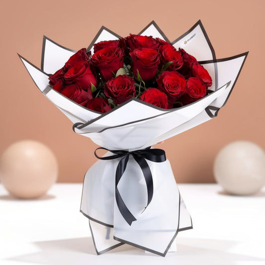 Imported red rose bouquet with white wrapping and black ribbon
