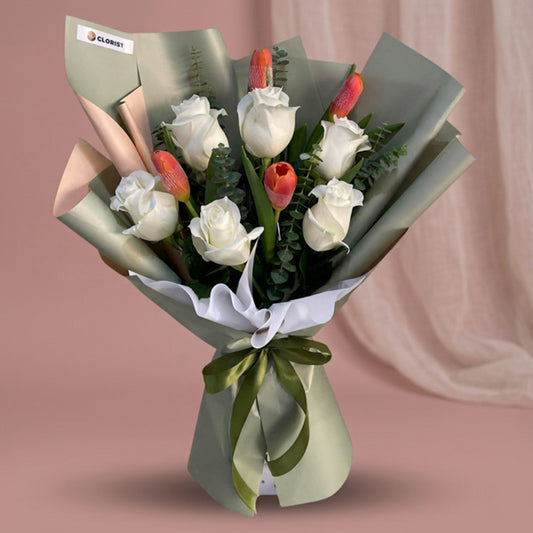 White imported roses and orange tulips bouquet with eucalyptus fillers