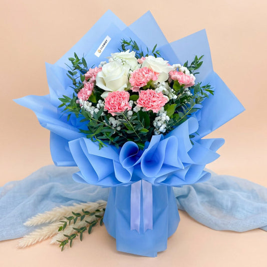 White rose and pink carnation bouquet with baby’s breath and eucalyptus fillers