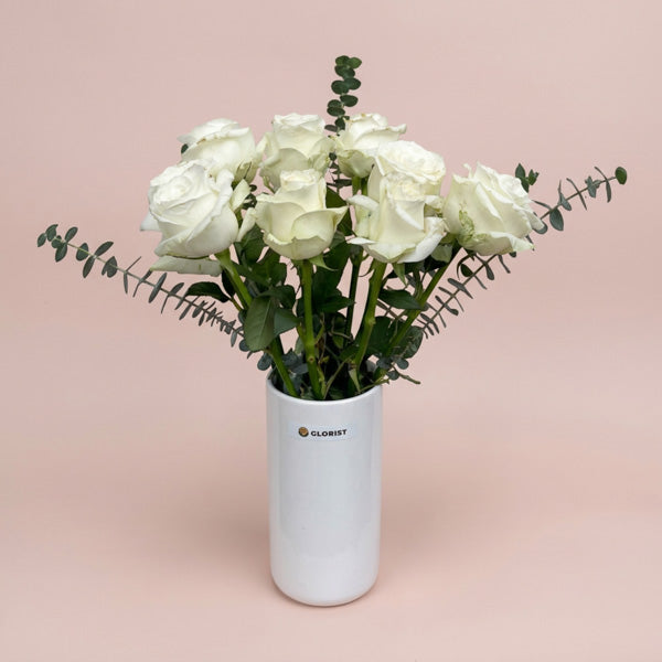 White China roses with aromatic eucalyptus baby blue foliage in a minimalist glass vase, ideal for weddings and sympathy gifts with same-day Metro Manila delivery