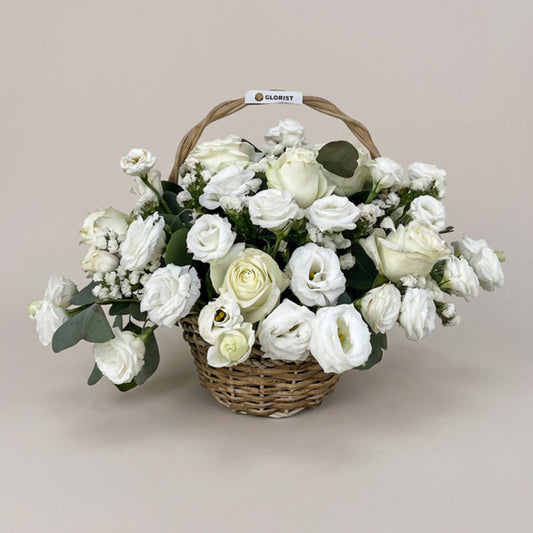 White China roses with lisianthus, white statice, and eucalyptus silver dollar in a handwoven basket, an elegant wedding and sympathy gift with same-day Metro Manila delivery