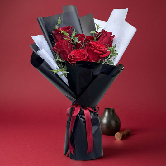 Zircon Dreamland bouquet with 6 red Ecuadorian roses and eucalyptus parvi in black and white wrap, tied with a maroon ribbon