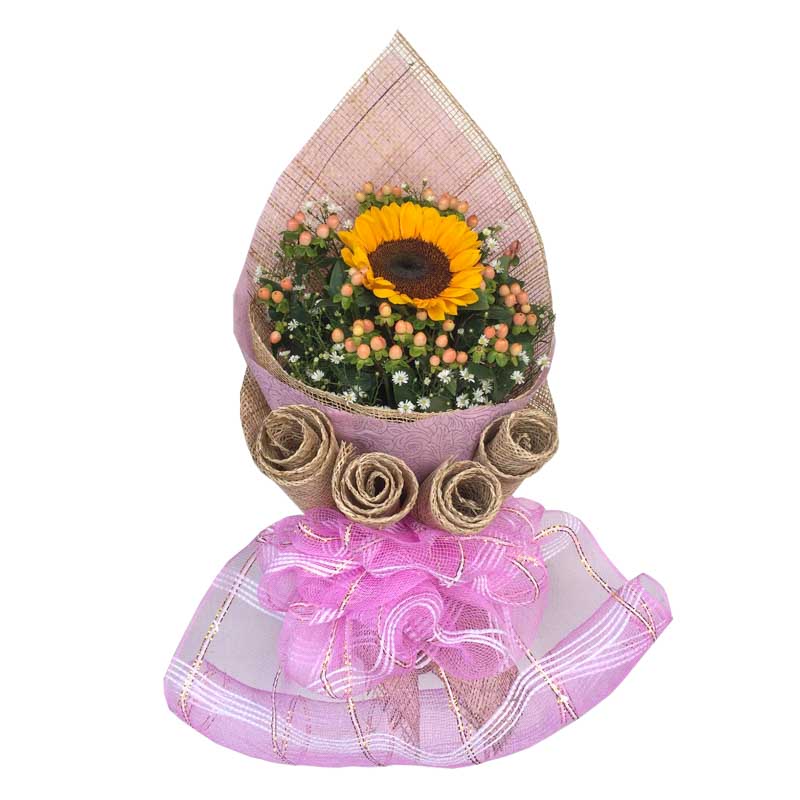 Vibrant sunflower centerpiece: A single sunflower complemented by Hypericum berries, Aster fillers, Korean wrap, and rustic burlap with net accents.