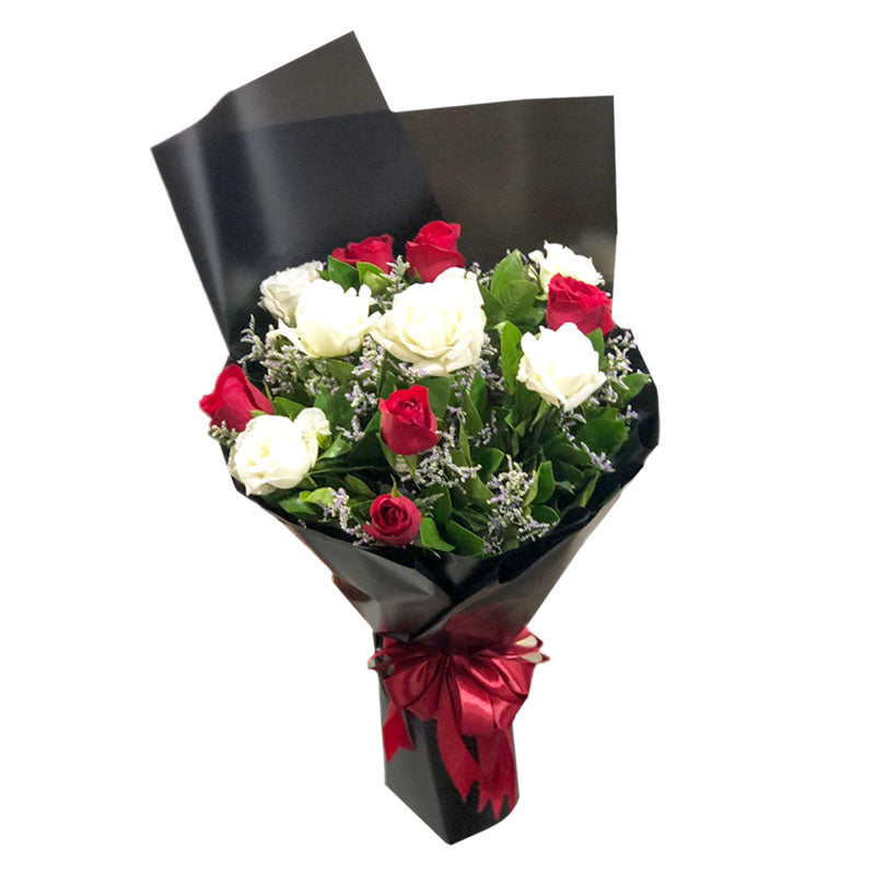 Captivating Bouquet of Red and White Roses complemented by delicate Misty Blue Fillers, beautifully arranged in a Korean-style wrap and adorned with a luxurious Satin Ribbon.