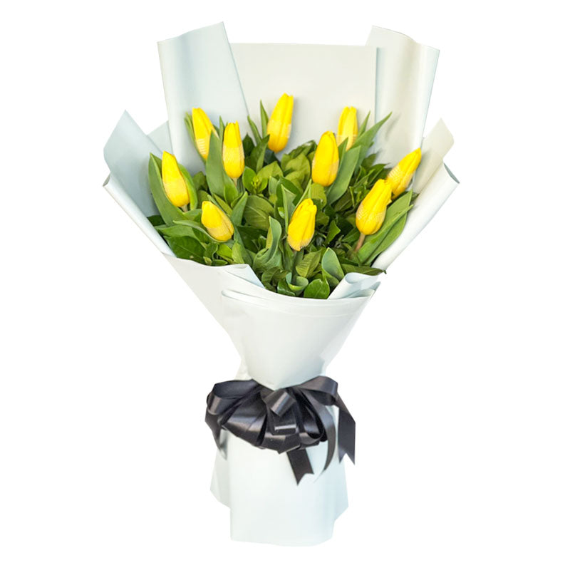 Radiant bouquet: ten yellow tulips elegantly wrapped in Korean style with a satin ribbon. A vibrant burst of sunshine and joy.