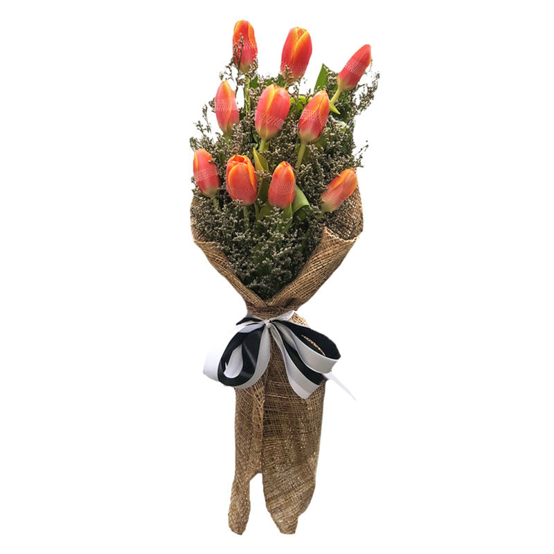 Vibrant bouquet: 10 orange tulips with misty blue fillers. Burlap wrap with satin ribbon, a perfect blend of color and texture