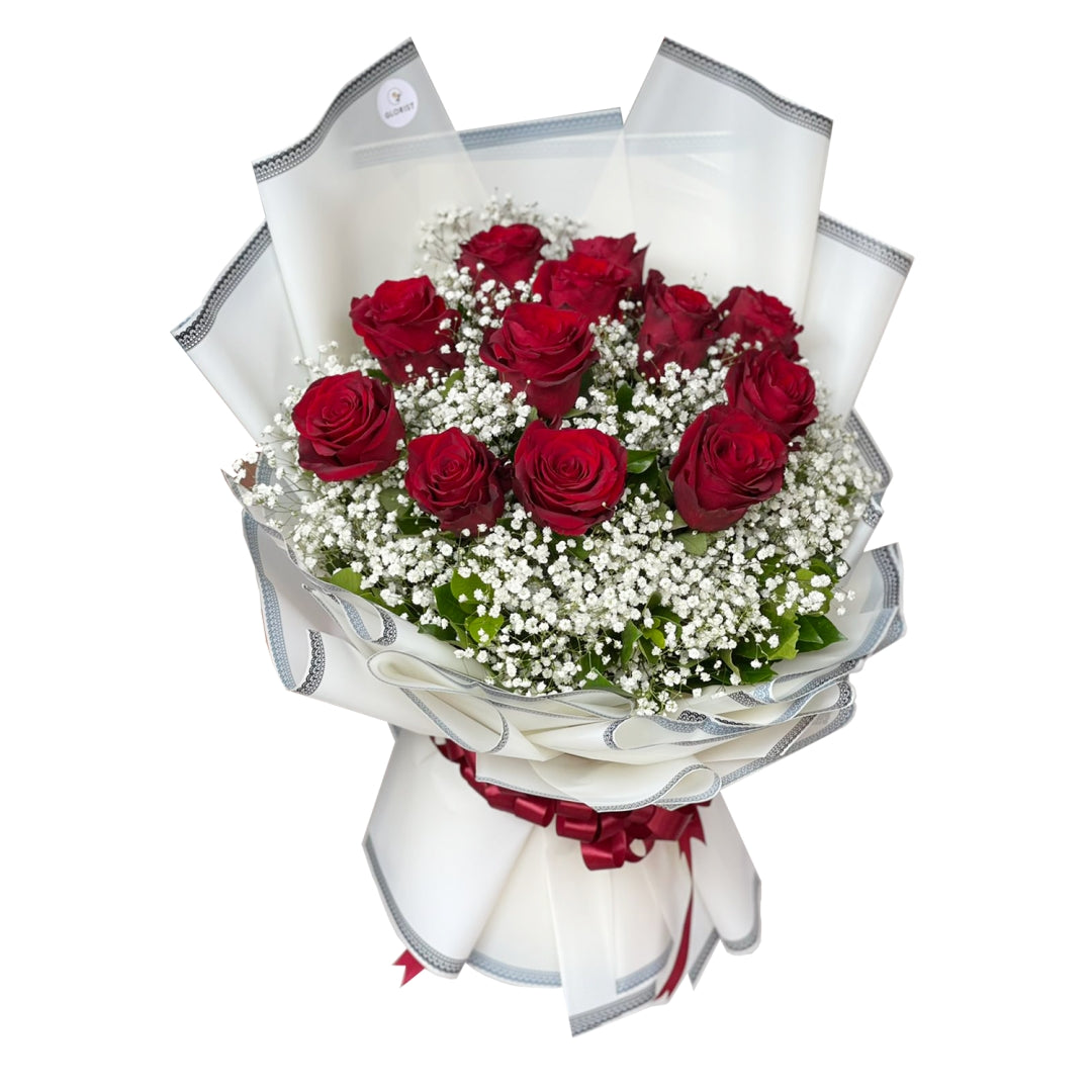 Classic Beauty: A stunning bouquet of one dozen exquisite Ecuadorian roses adorned with delicate gypsophila fillers. The bouquet is tastefully wrapped in a Korean-style packaging featuring an elegant border and finished with a luxurious satin ribbon. This arrangement combines timeless beauty with a touch of sophistication, making it a perfect gift for any occasion.